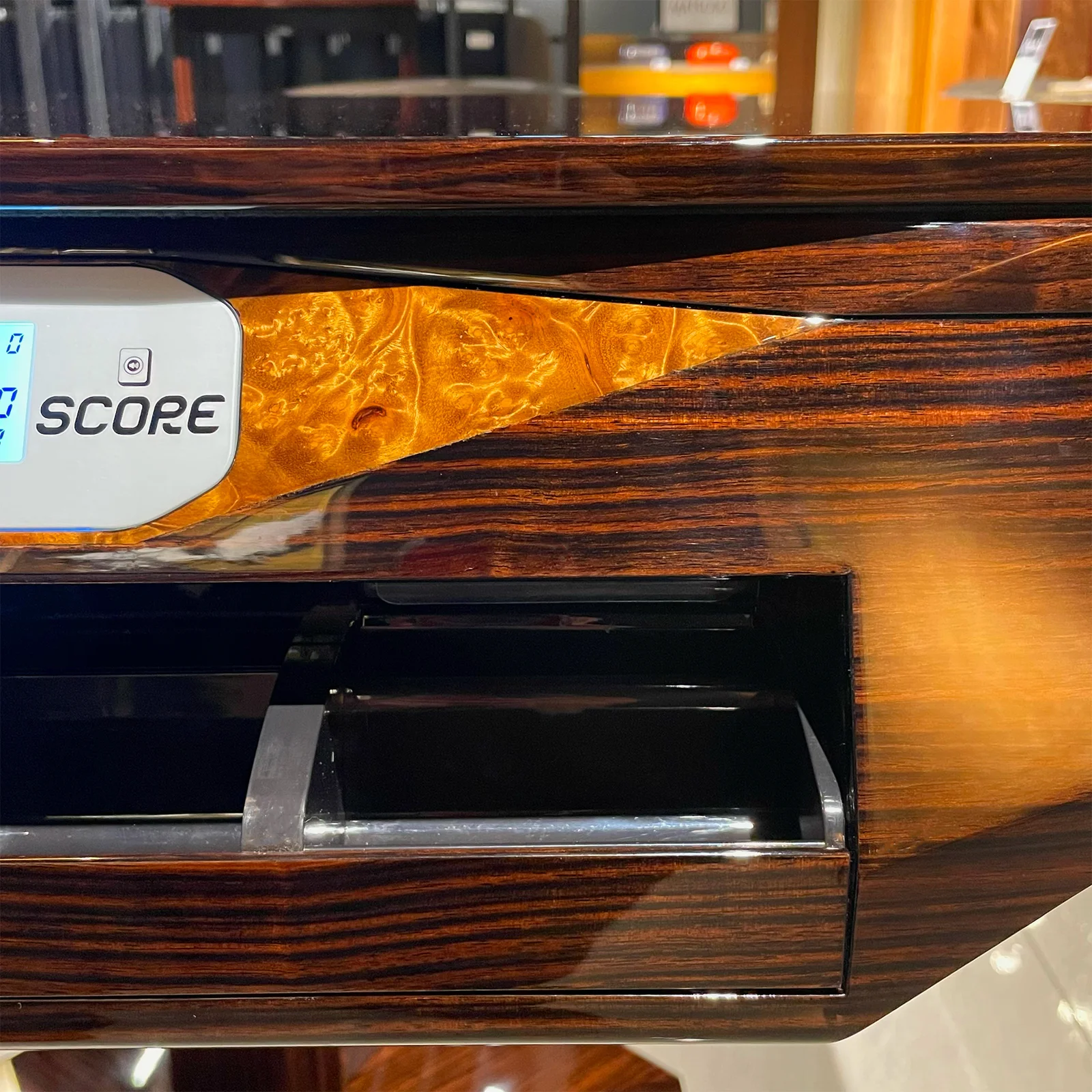 Burl-wood inlay detail beside the SCORE display on the Matsuso bespoke table